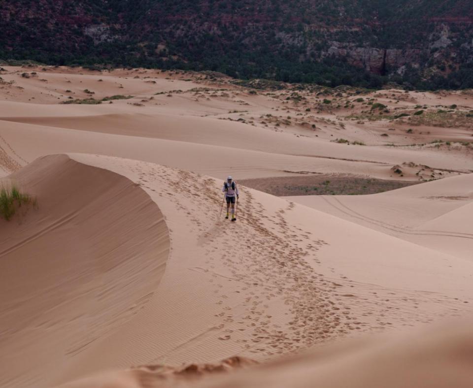 Person running in sand as part of the Grand to Grand Ultra