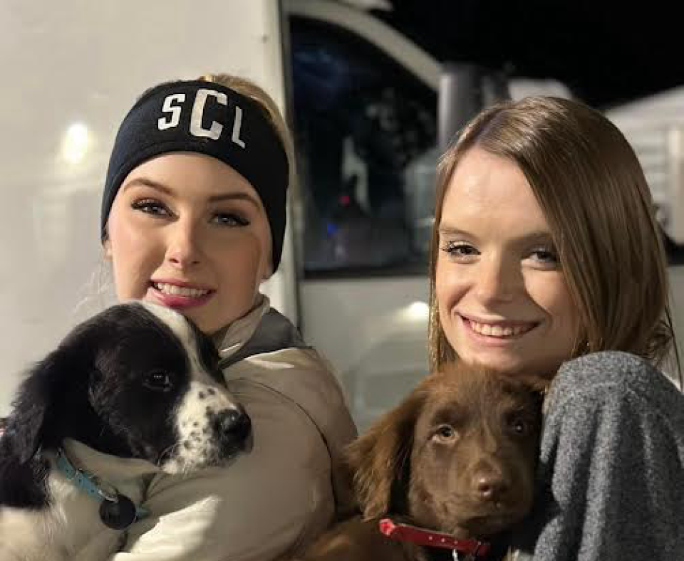 Skylar Clark and her sister Halee loading puppies for a transport