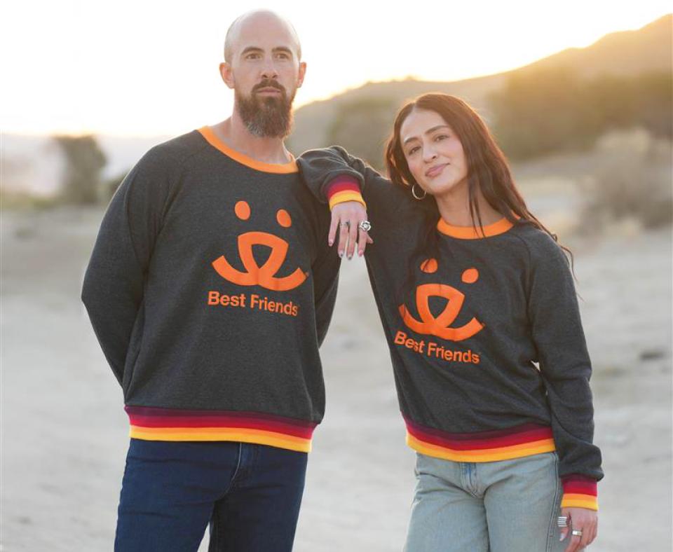 Two people wearing Best Friends logo sweaters