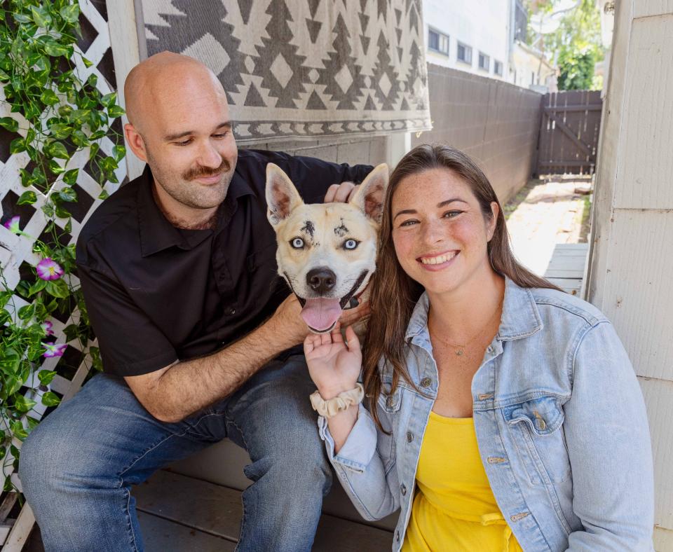 Bonny the dog with adopters Bevin and Cam