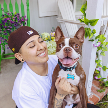 Person with a smiling boston terrier