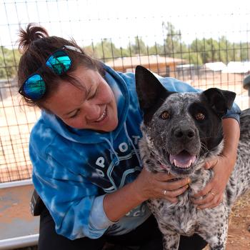 Smiling woman hugging a dog