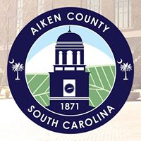 Aiken County Animal Shelter, (Aiken, South Carolina), logo Aiken County blue tower against green and white background inside blue circle with white text