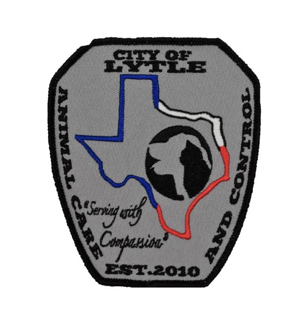 City of Lytle Animal Care & Control (Lytle, Texas) logo black outline of patch black text top bottom and sides blue white and red outline of Texas in middle black silhouette of cat grey silhouette of dog layered in black circle inside outline of texas