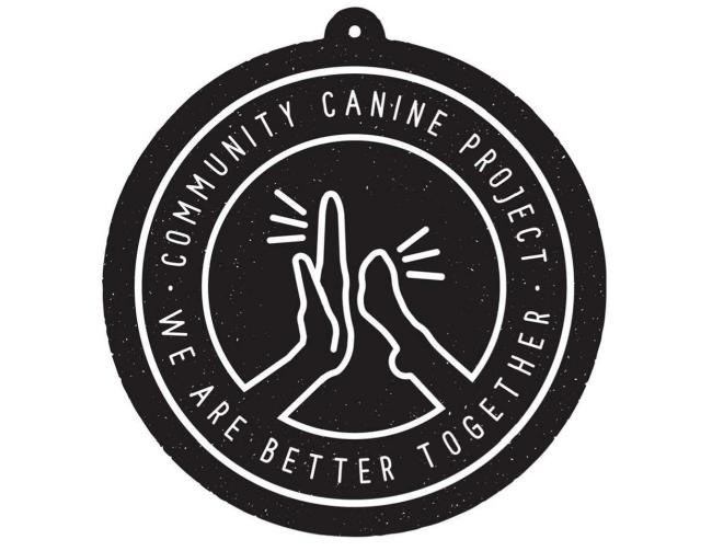 Community Canine Project AZ (Phoenix, Arizona) logo black with white speckles pet tag with white circle inside white lettering small white inner circle drawn white hand and paw high five