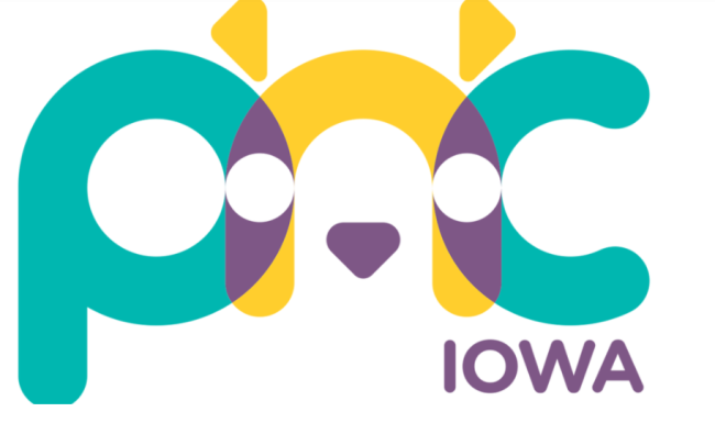 Paws-N-Claws Iowa, (Newton, Iowa) logo turquoise purple and yellow letters with animal face