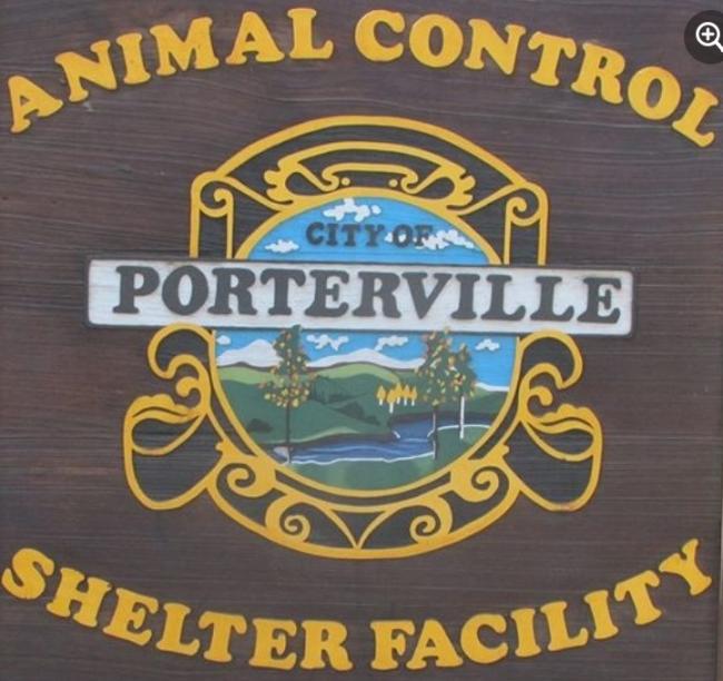 Porterville Police Department/Porterville Animal Services, (Lindsay, California), brown sign with a painting of a river running through green hills framed by text above and below
