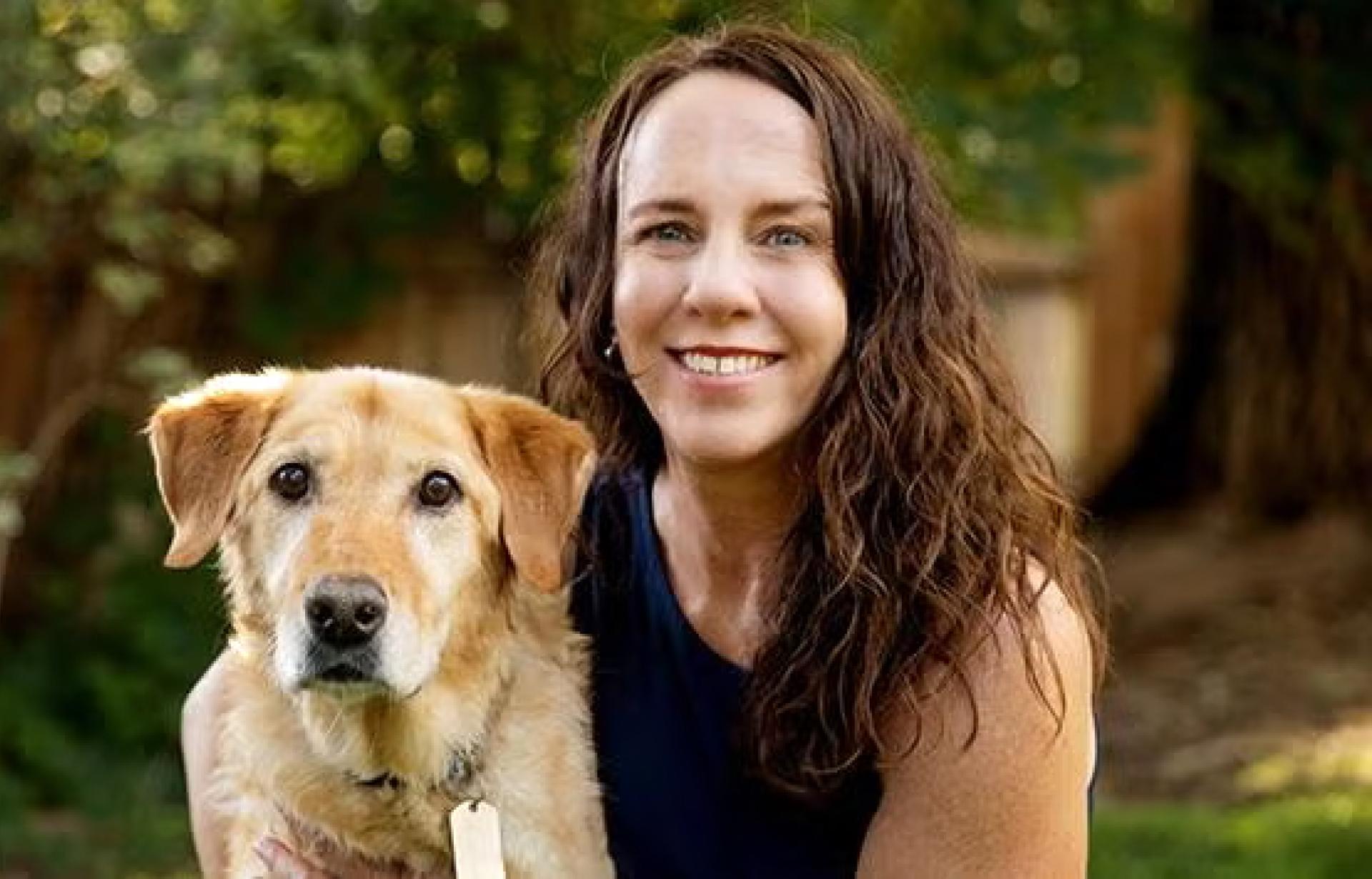 Amber Ayers beside a dog