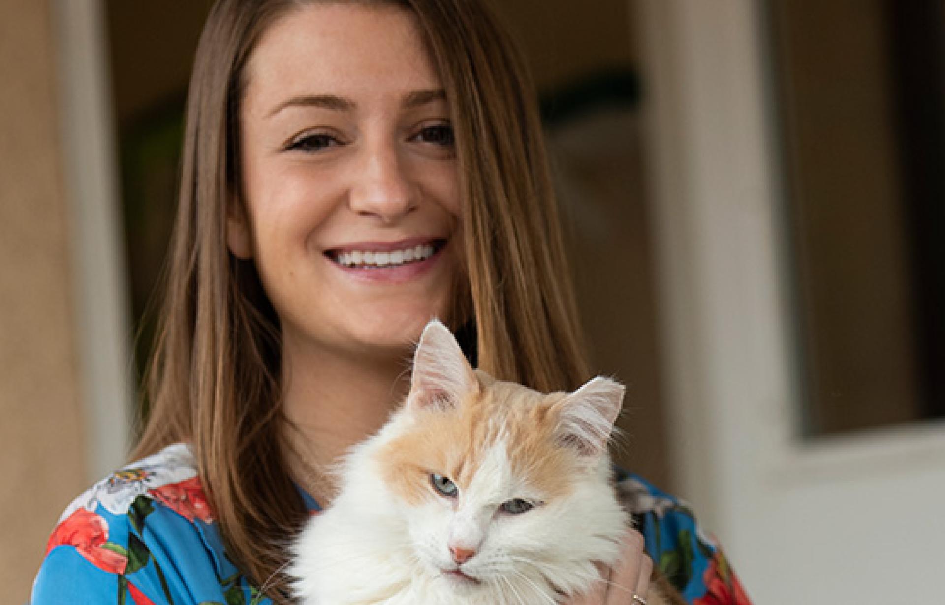 Elise Traub holding a white and orange cat