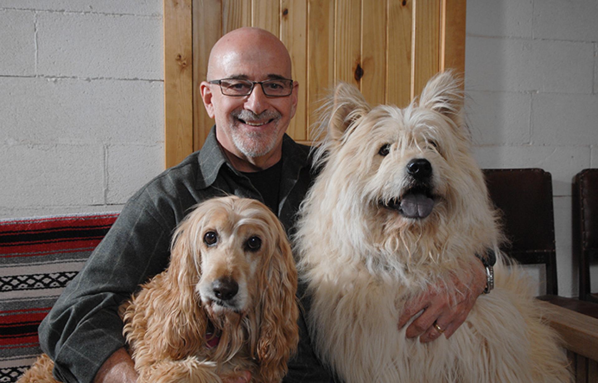 Francis Battista with two large dogs