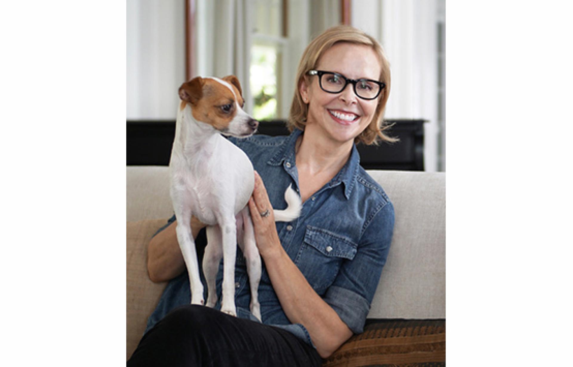Lona Williams holding a small dog on her lap