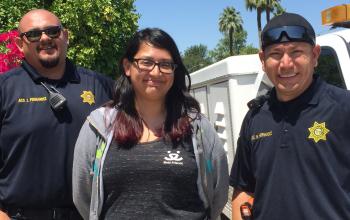 Two animal control officers stand beside a Best Friends employee