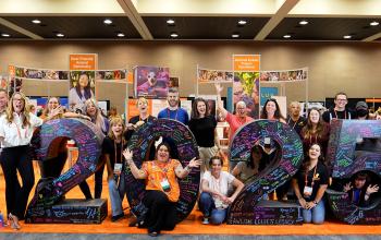 Group of people around a large 2025 number