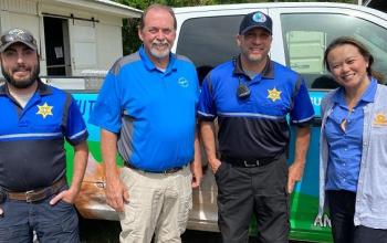 Shelter staff and BF staff member standing in front of truck