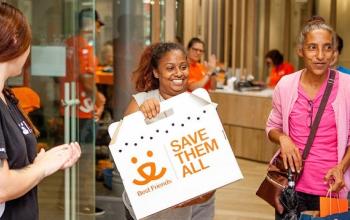 Woman holding a best friends cat carrier standing next to woman in pink top