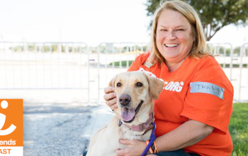 Tawny Hammond from Best Friends Animal Society sitting with a dog