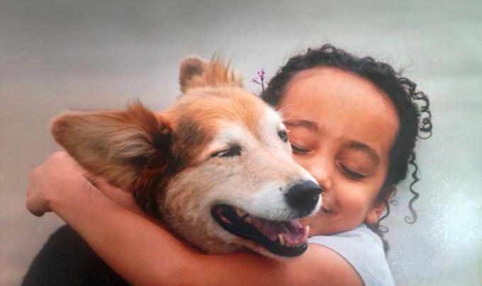 Sophie hugging her dog