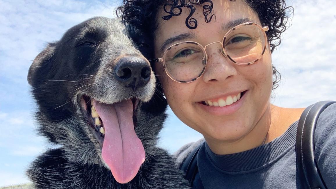 Yogi the dog with is smiling person