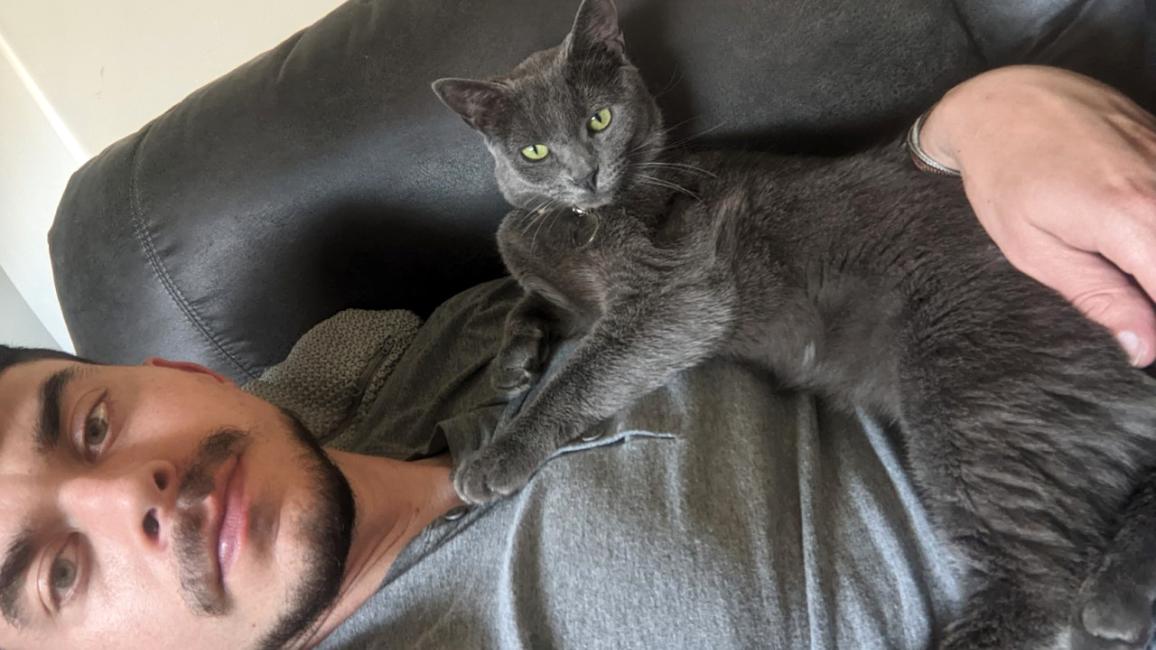 Esmerelda the cat lying on her person Chase