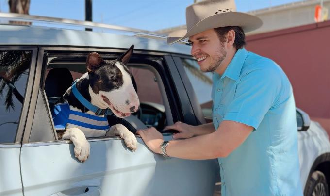 Chico the dog in Steven Szydio's vehicle looking out the window for Adventure Buddy Day