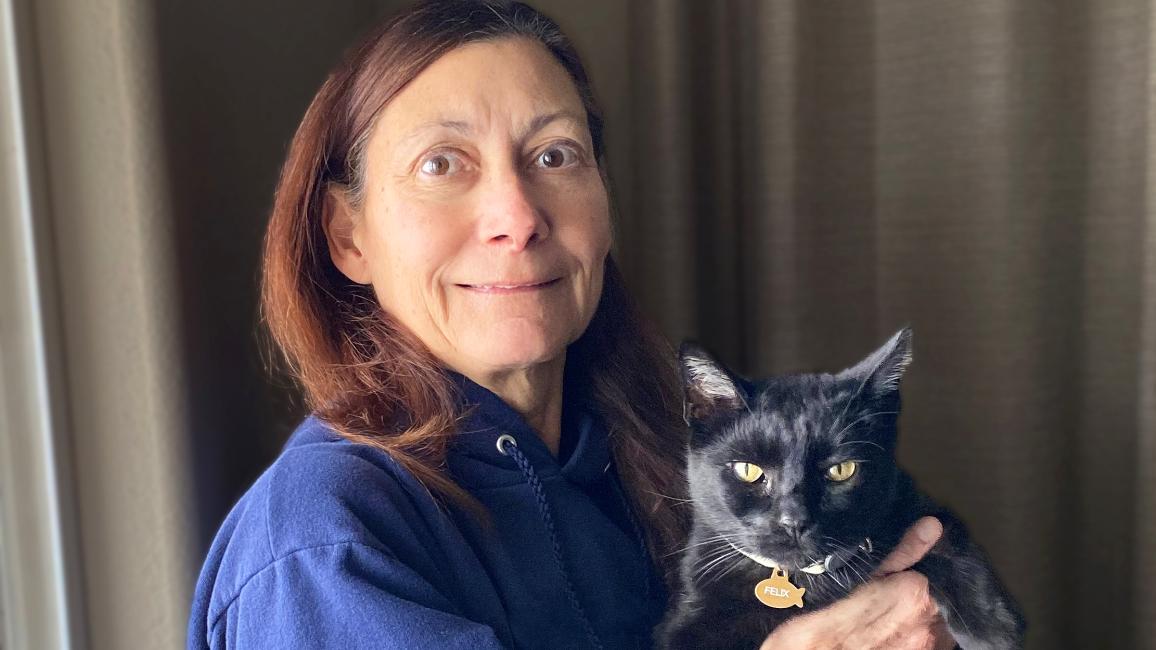 Alida Collewyn holding Felix, her black cat