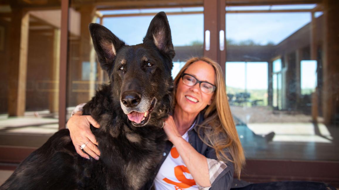 Julie Castle hugging Shadow the dog