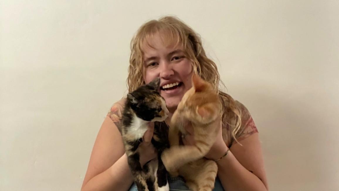 Jenna Sume holding Bug and another cat