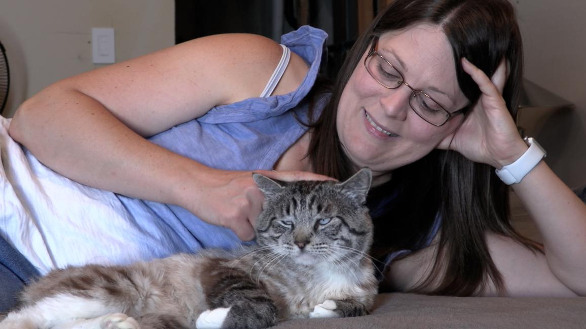 Candace lying next to Hedwig the foster cat