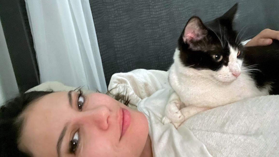 Lil the cat lying on Kelly's chest