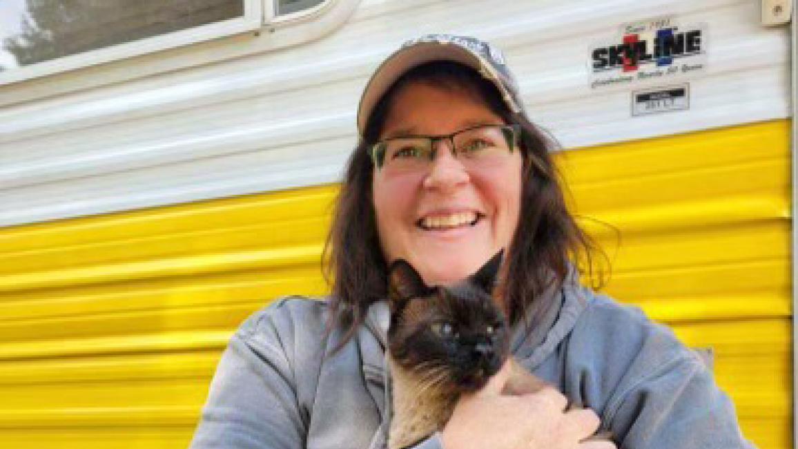 Stormy Shafer holding Abby the Siamese cat