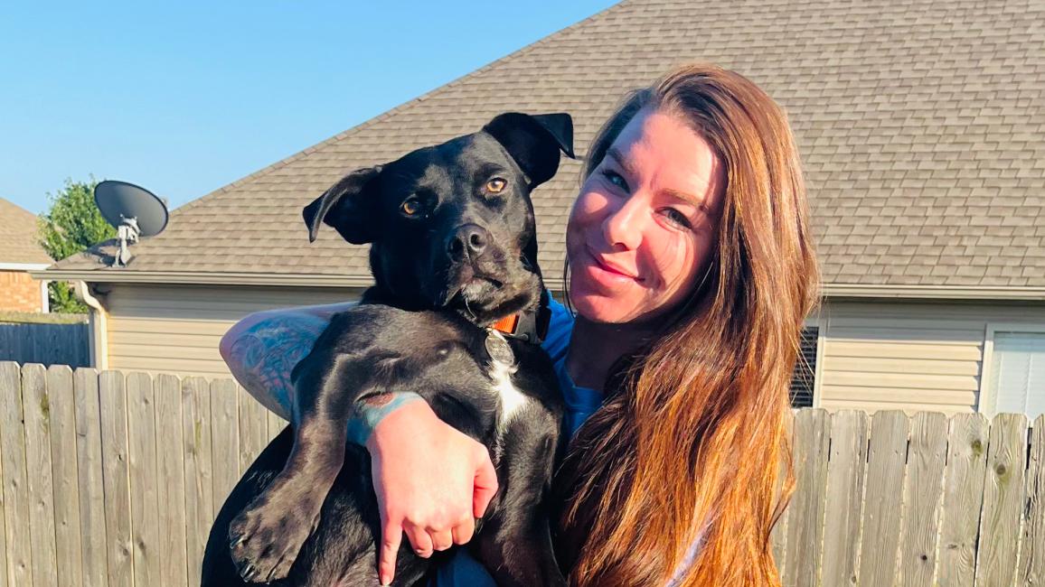 Heather holding Goose the dog