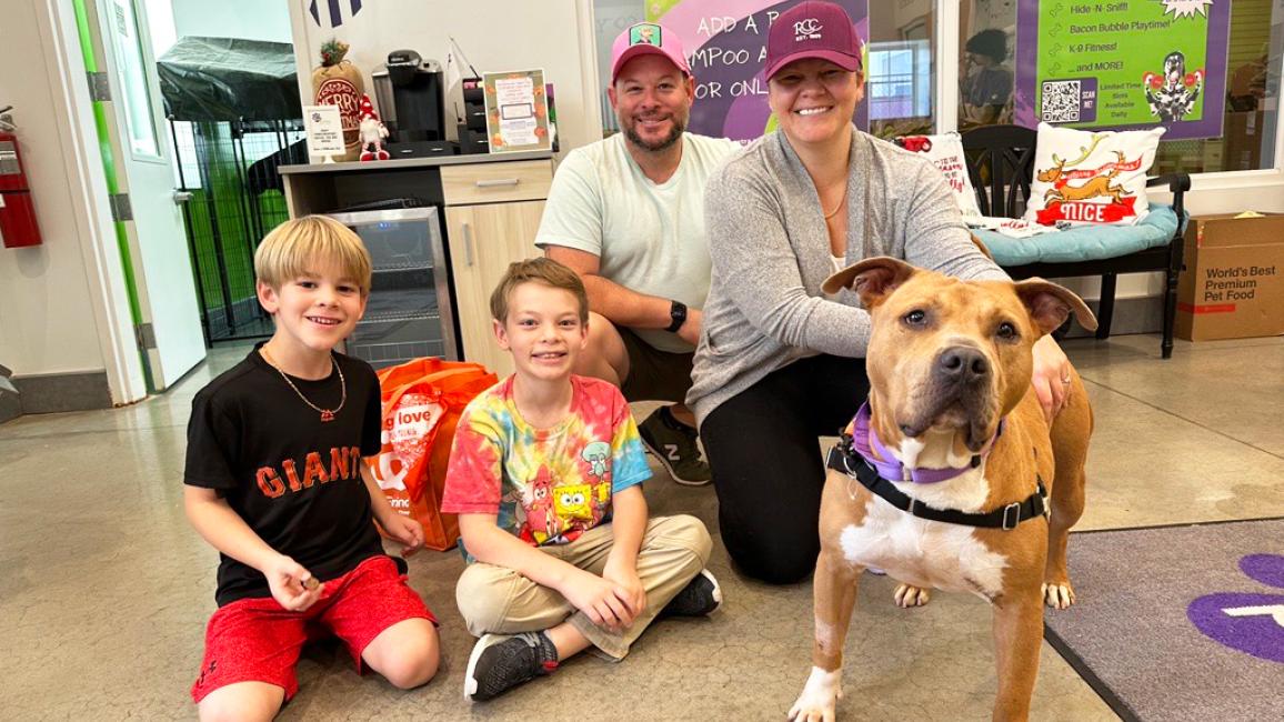 Potato the blocky-headed pooch with his new family