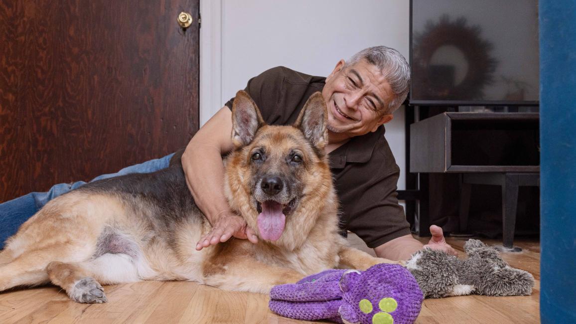 Jaime Gallardo lying on the floor with Dublin the dog