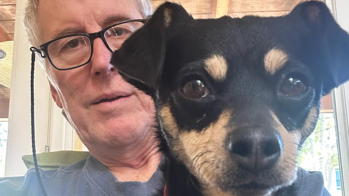 Eleanor the dog with Mark behind her