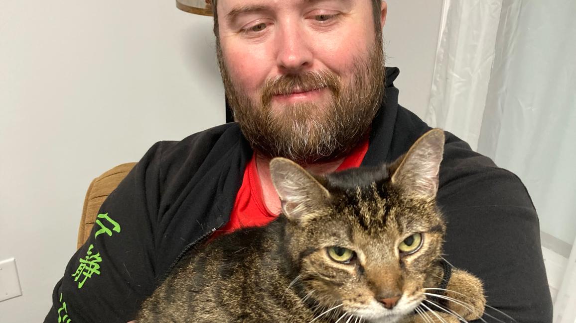 Erick Allen holding his cat Eddie