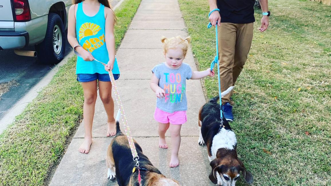 The Cochran family walking two basset hounds