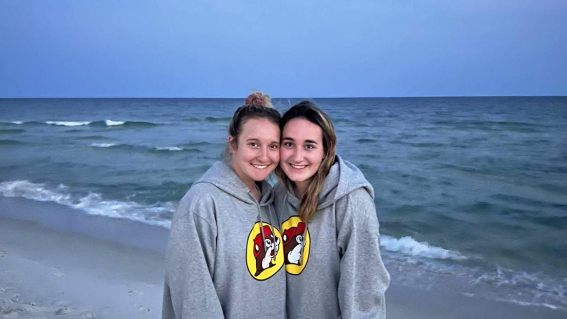 Foster volunteers Lauren Burgess and Jill Church together on a beach