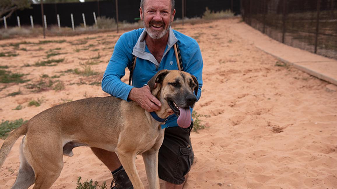 Southeast the dog being hugged by caregiver, Matt Fisher