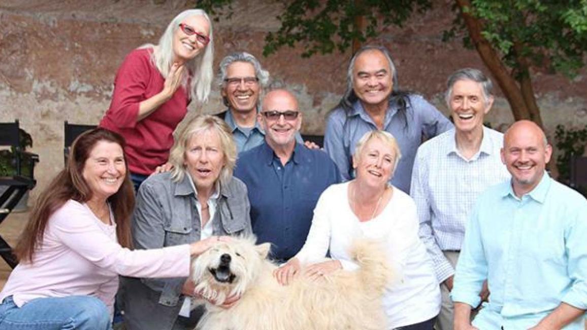 Group shot featuring nine of the co-founders of Best Friends Animal Society with a dog