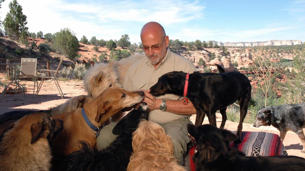 Francis Battista with multiple dogs outside in Angel Canyon