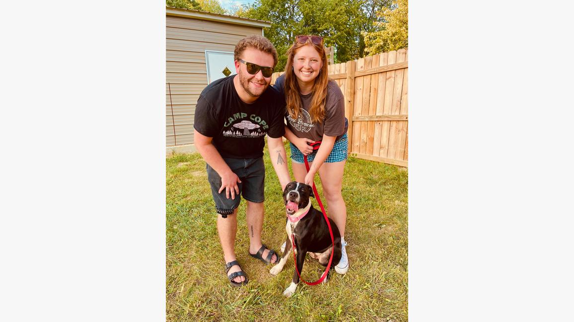 Golfy the dog from Pets of Ohio Rescue Team in a yard with his new family