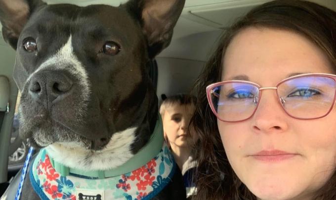 Ruby Fooks beside a dog in a vehicle