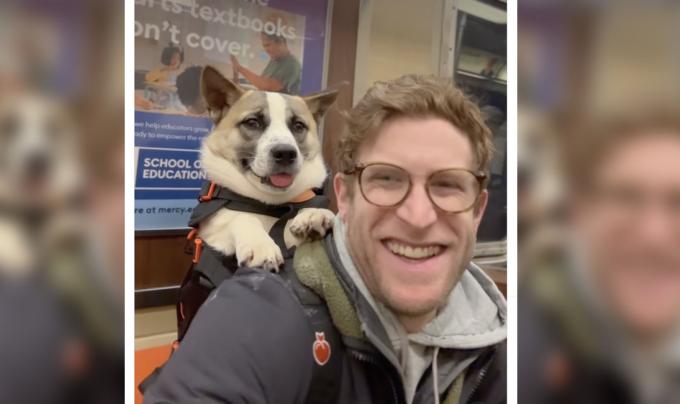 Bryan Reisberg smiling while carrying a dog in a backpack