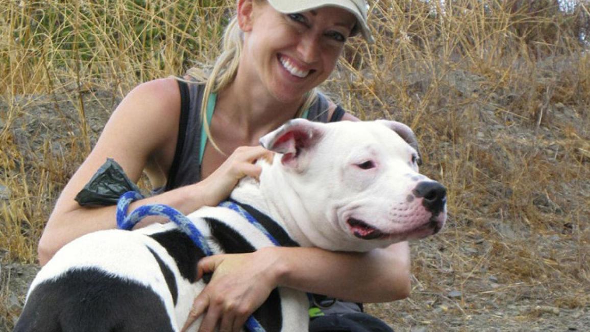 Volunteer Victoria Vertuga with a pit bull terrier