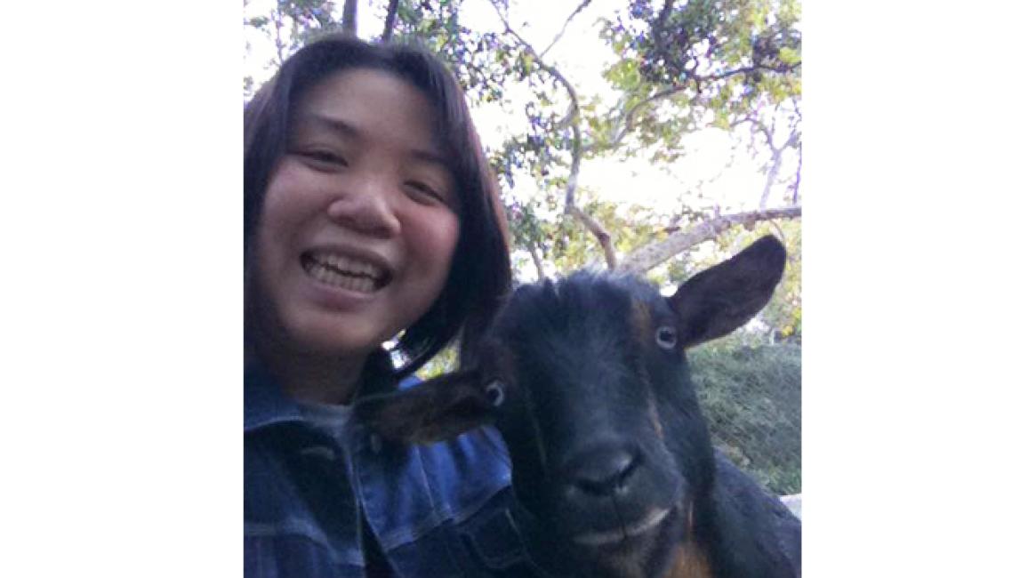 Volunteer Jenny with a goat