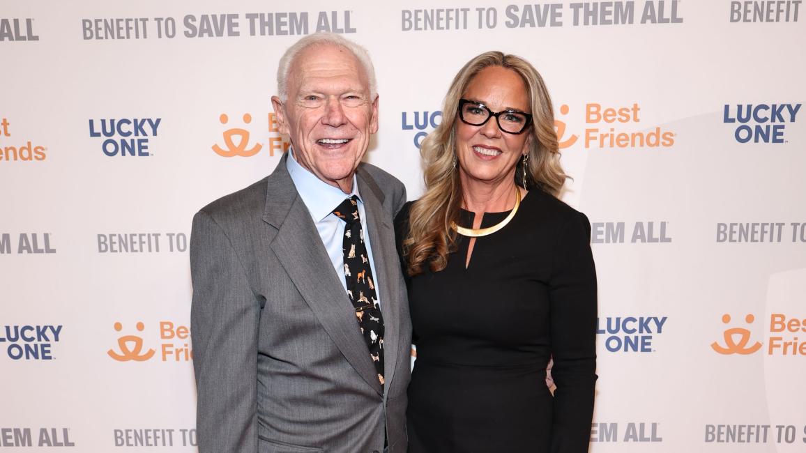 Rich Avanzino and Julie Castle in front of a Best Friends Benefit to Save Them All backdrop