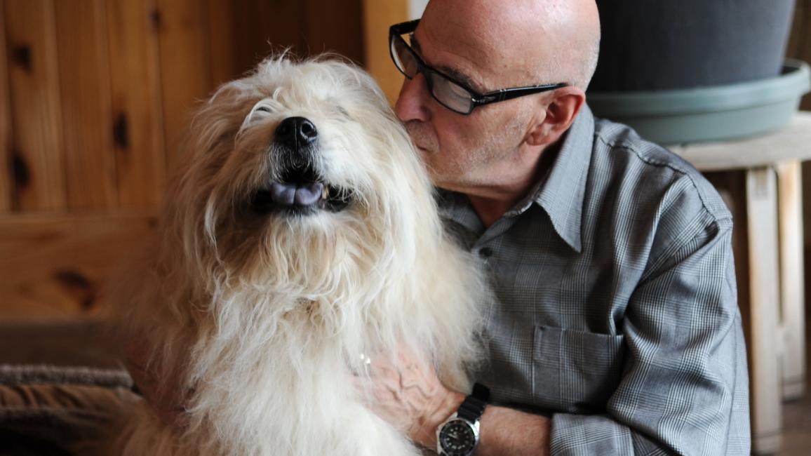 Best Friends co-founder Francis Battista kissing Teddy the dog
