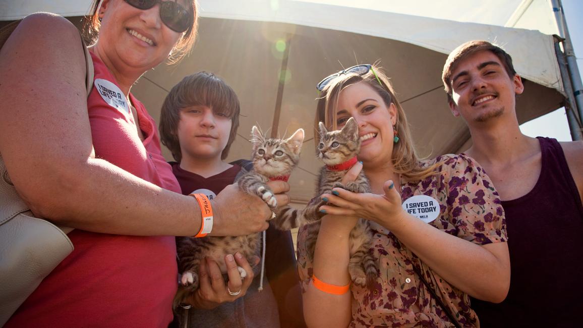Family holding kittens they adopted