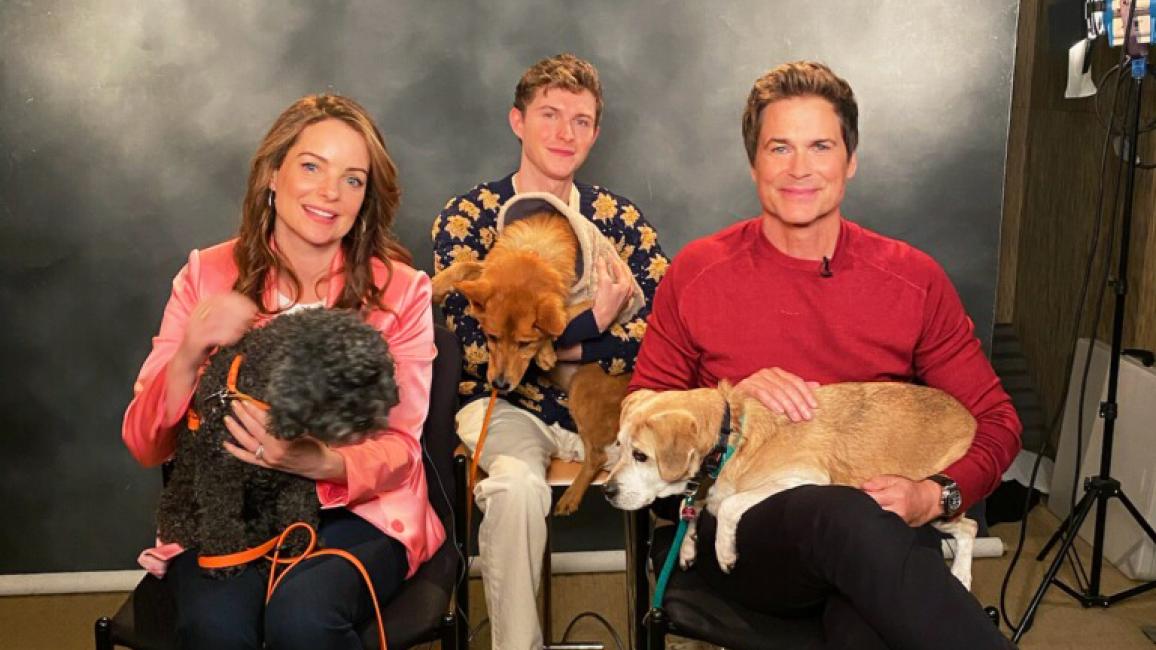 Rob Lowe, Kimberly Williams-Paisley and Johnny Berchtold of Netflix's DOG GONE holding dogs