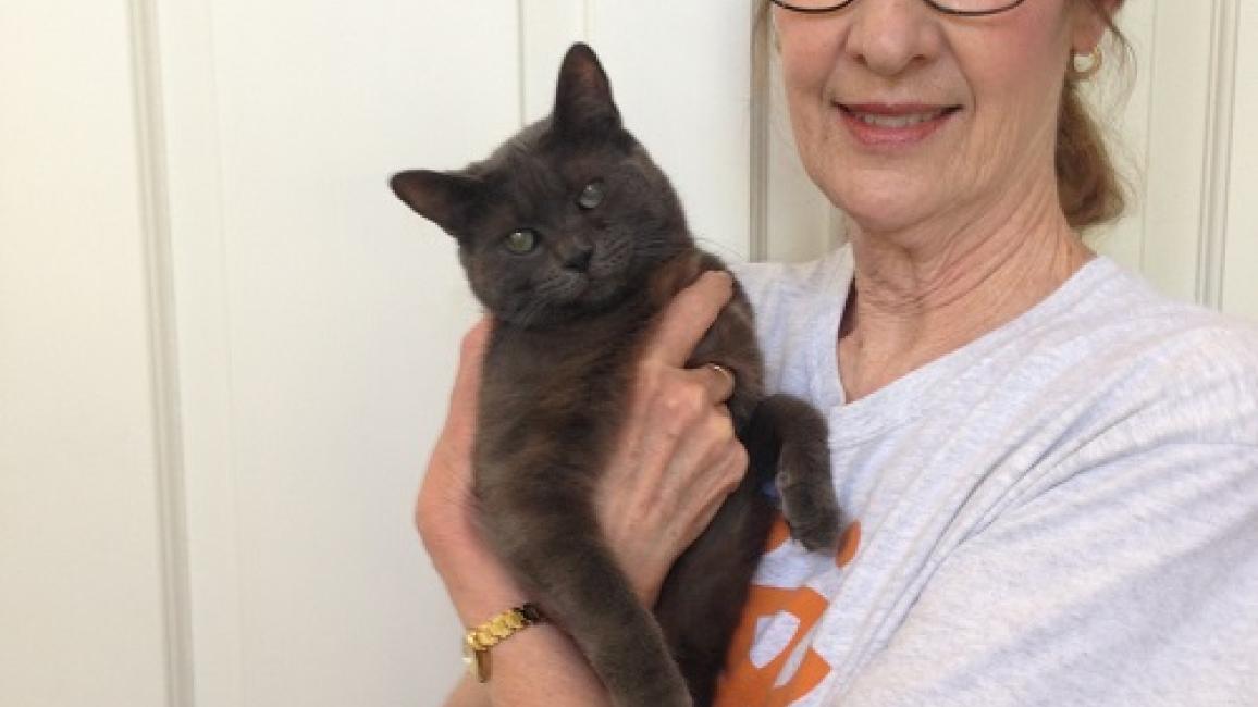 Volunteer Pat holding a cat